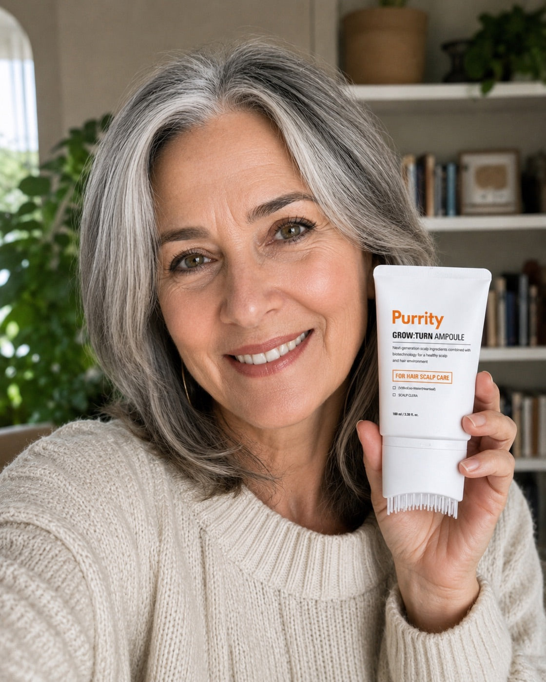 A smiling customer holding the Purrity Grow:Turn ampoule at home